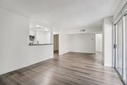 Los Angeles apartment for rent - A spacious room with wooden flooring and white walls.