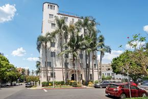 Los Angeles apartment for rent - A white building with a red car parked in front of it.
