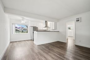 Gardena apartment for rent - A spacious room with wooden flooring and white walls.