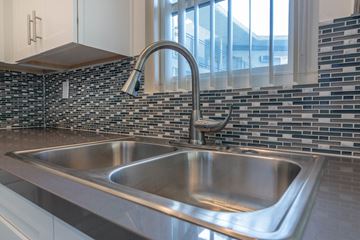 Los Angeles apartment for rent - A modern kitchen with a stainless steel sink and a chrome faucet.