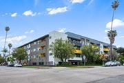 Los Angeles apartment for rent - A modern apartment building with a parking lot in front.