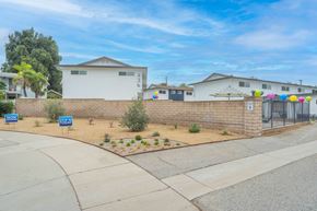 Covina apartment for rent - A residential street with houses and a blue sky.