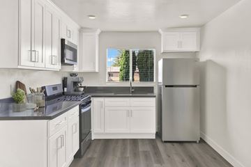Los Angeles apartment for rent - A modern kitchen with white cabinets and a stainless steel refrigerator.
