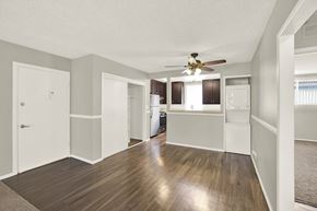Downey apartment for rent - A spacious room with a ceiling fan and wooden flooring at The Square in Downey, CA, 90242