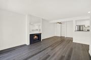 Reseda apartment for rent - A modern living room with a fireplace and wood flooring.