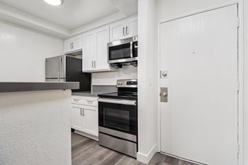 Los Angeles apartment for rent - A kitchen with white cabinets and stainless steel appliances.