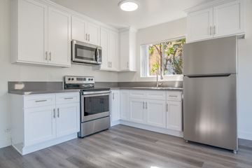Los Angeles apartment for rent - A kitchen with white cabinets and a stainless steel refrigerator.