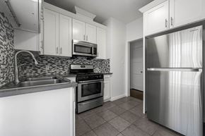 Los Angeles apartment for rent - A kitchen with a refrigerator, sink, and stove.