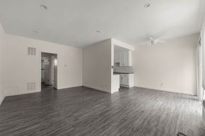 West Hollywood apartment for rent - the living room and kitchen of an empty house with wood floors