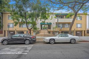 West Hollywood apartment for rent - Two cars parked in front of a building with the number 7558 on it.