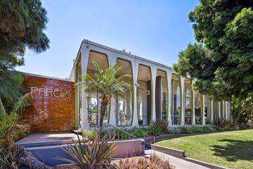 Downey apartment for rent - A modern building with the sign "PARC" on the side.