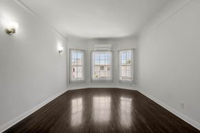 Los Angeles apartment for rent - A room with wooden floors and white walls.