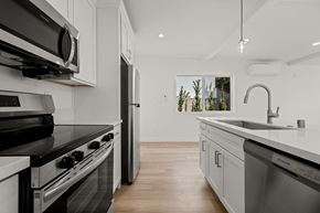 Los Angeles apartment for rent - A modern kitchen with a black stove top oven and a white counter top.