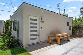 Los Angeles apartment for rent - A small building with a door and a bench outside.
