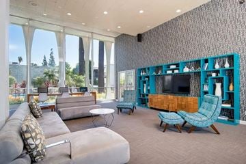 Downey apartment for rent - A living room with a grey couch and a blue chair.