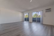 Woodland Hills apartment for rent - A spacious room with wooden flooring and sliding glass doors.