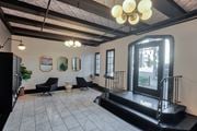 Los Angeles apartment for rent - A black and white living room with a large television.