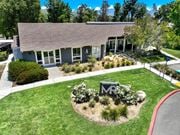 Canyon Country apartment for rent - the front of a building with a lawn and a sign in front of it at Monterra Ridge Apartments, Canyon Country, California