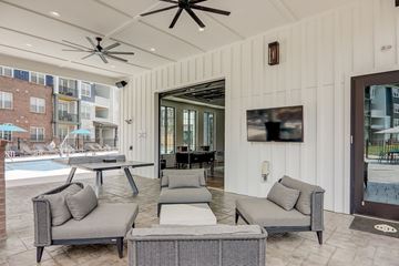 Asheville apartment for rent - a living room with couches and chairs next to a pool