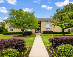 Fayetteville apartment for rent - A building with a green lawn in front.