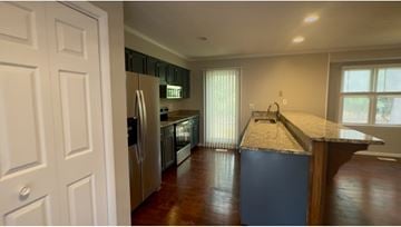 Fayetteville apartment for rent - A kitchen with a refrigerator, oven, and sink.