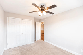 Lynchburg apartment for rent - a bedroom with a ceiling fan and a door to a closet