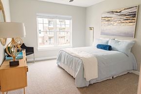 Clayton apartment for rent - A bedroom with a bed, a nightstand, and a window.