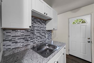 Greensboro apartment for rent - A kitchen with a sink and a white door.
