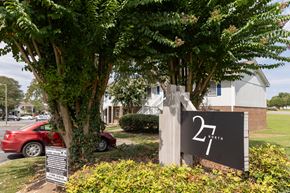 Greensboro apartment for rent - A sign with the number 27 on it is in front of a tree.