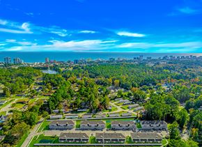 Myrtle Beach apartment for rent - A bird's eye view of a residential area with houses and trees.