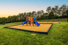 Winston Salem apartment for rent - A playground with a yellow sandbox and a blue slide.
