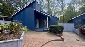 Fayetteville apartment for rent - A blue house with a white fence and a brick walkway.