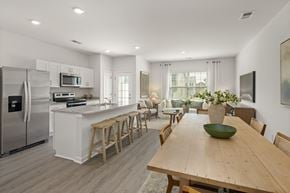 Whitsett apartment for rent - A modern kitchen with a wooden table and chairs.
