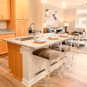 Clayton apartment for rent - A kitchen with a granite countertop and a dining table set for four.