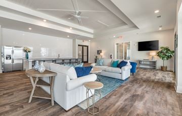 Myrtle Beach apartment for rent - A modern living room with a white sofa and a wooden coffee table.