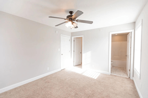 Lynchburg apartment for rent - a living room with a ceiling fan and a door to a bathroom