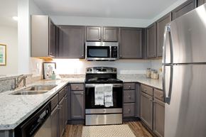 Wilmington apartment for rent - A modern kitchen with a stainless steel refrigerator and black appliances.