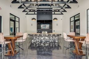 Asheville apartment for rent - a large room with tables and chairs and a kitchen in the background in Asheville