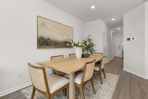 Whitsett apartment for rent - A dining room with a wooden table and chairs.