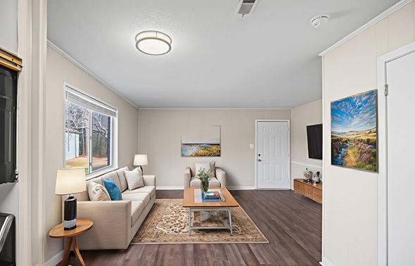 Fayetteville apartment for rent - A living room with a couch, a coffee table, and a painting on the wall.