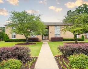 Fayetteville apartment for rent - A building with a green lawn in front of it.