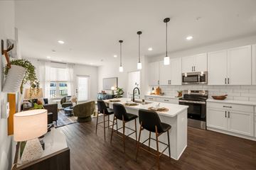 Sanford apartment for rent - A modern kitchen with white cabinets and a large island.