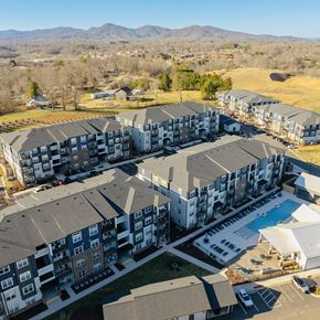Asheville apartment for rent - an aerial view of apartments and a swimming pool in a city