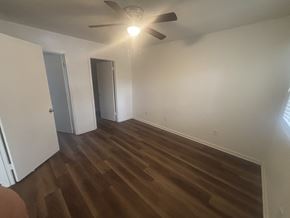 Winston Salem apartment for rent - A room with a ceiling fan and wooden flooring.