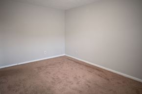 Fayetteville apartment for rent - A room with a carpeted floor and white walls.