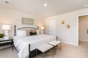 Longs apartment for rent - A bedroom with a bed, nightstand, and chair.
