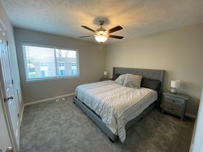Fayetteville apartment for rent - A bedroom with a bed, nightstand, and window.