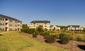 Fayetteville apartment for rent - Apartment complex with green grass in front.