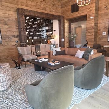 Sanford apartment for rent - A living room with a brown couch and grey chairs.