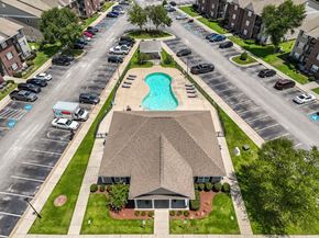 Parkton apartment for rent - A swimming pool is located in the middle of a parking lot.